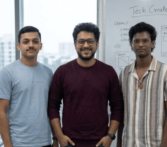 The CanDoMinds team: three engineers standing together in front of a whiteboard in the office.